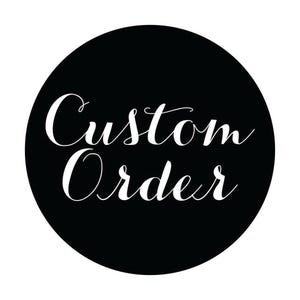 May include: A black circular graphic featuring the words "Custom Order" in white, cursive script. The text is centrally positioned within the black circle, creating a simple and elegant design. The contrast between the black background and white text makes the words stand out clearly.