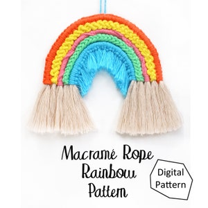 May include: A colourful macrame rainbow wall hanging with a light blue centre and a white fringe. The text "Macrame Rope Rainbow Pattern" and "Digital Pattern" is visible below the rainbow.