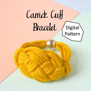 May include: A yellow braided bracelet with a silver toggle clasp. The bracelet is made with a Carrick cuff knot. The text "Carrick Cuff Bracelet Digital Pattern" is visible in the image.