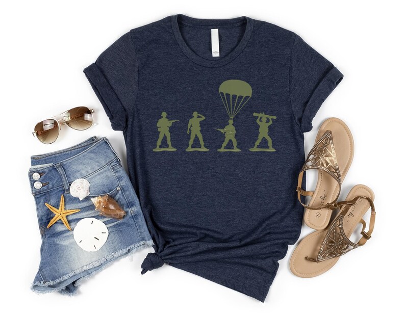 a casual outfit consisting of a navy blue t-shirt with a graphic design, denim shorts, sunglasses, sandals, and a starfish.