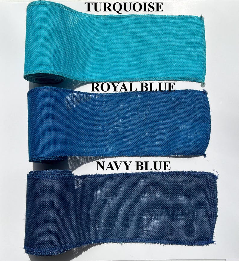 May include: Three rolls of burlap ribbon in turquoise, royal blue, and navy blue. The ribbon is tightly woven and has a textured appearance. The colors are vibrant and saturated, with the names of the colors printed above each roll.