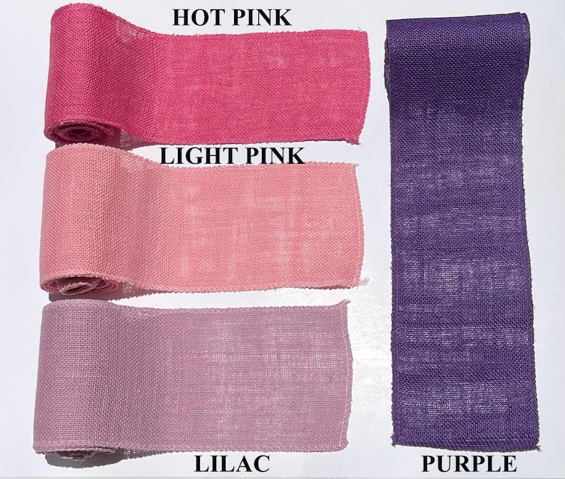 May include: A selection of burlap ribbon rolls in various shades of pink and purple. The colors include hot pink, light pink, lilac, and purple. The text labels each color. The ribbon is likely used for crafts and decorations.