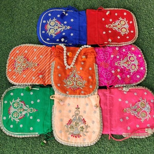 May include: Assortment of nine colorful drawstring pouches with intricate embroidery designs. The pouches are made of various fabrics and feature different colors, including orange, pink, green, blue, and red. Each pouch has a unique design with floral and paisley motifs.