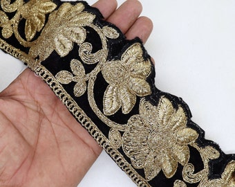 May include: Black velvet trim with gold embroidered floral designs. The trim has a scalloped edge and a chain-like border.