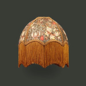Made to order. Handmade covered with printed William Morris fabric, decorated with matching old gold trim and fringes.