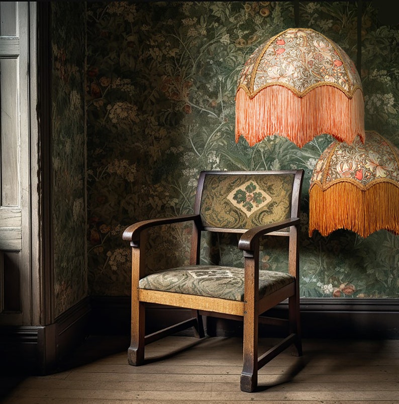 May include: A wooden armchair with a patterned fabric seat and back sits in a room with patterned wallpaper and two lampshades with fringe. The lampshades are covered in a floral pattern.