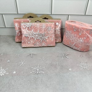 2 total yards of 6cm wide pastel pink with silver snowflakes and stars tulle trim
