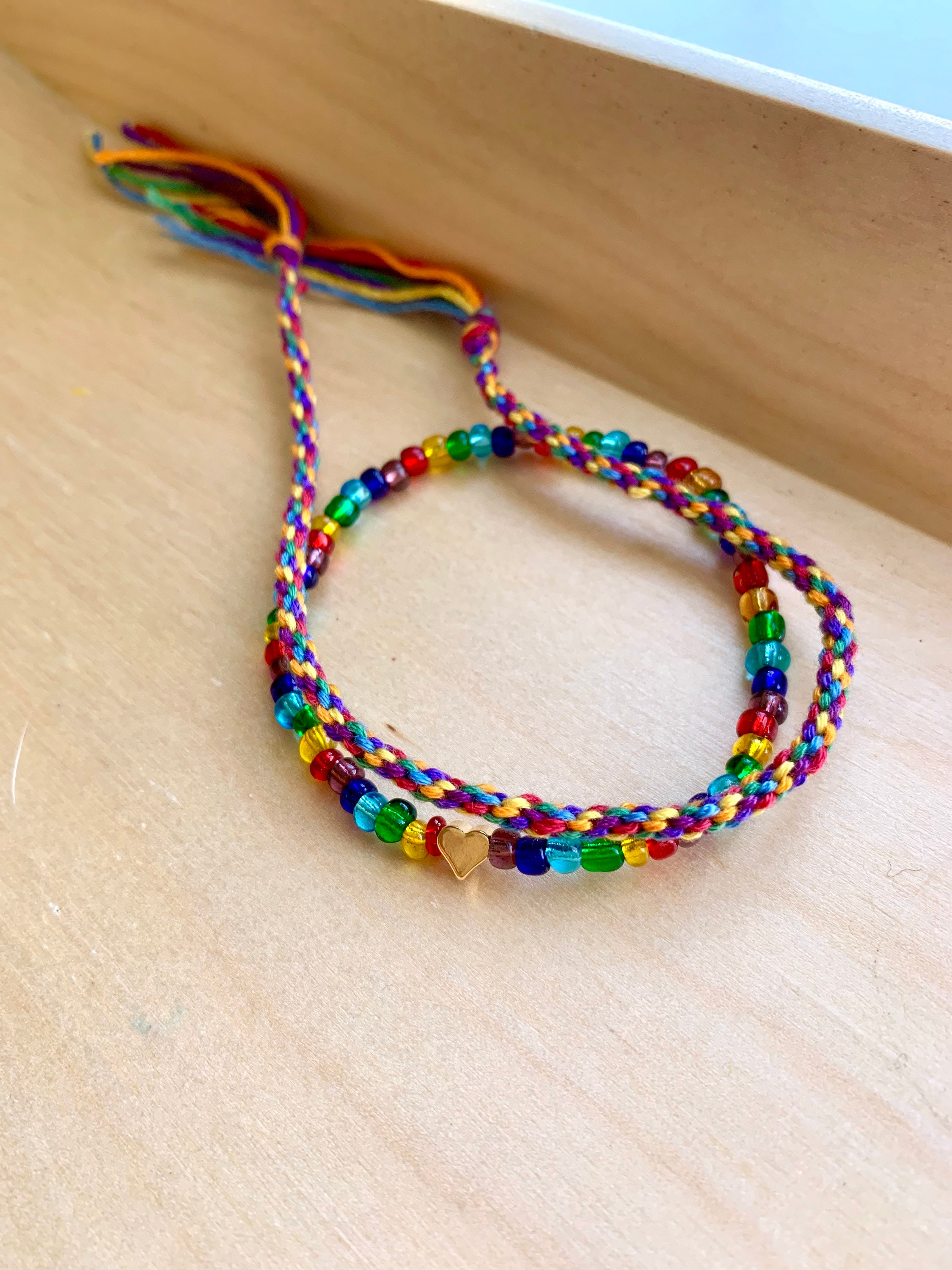 Rainbow beaded bracelet with heart charm. Braided bracelet. Etsy