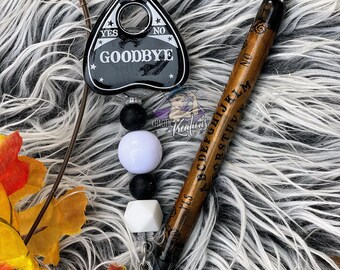 ouija planchette and pen