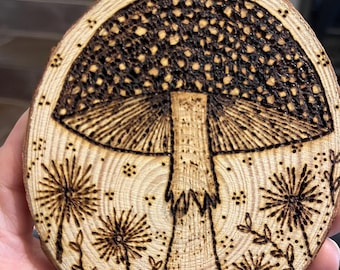 Wood burnt mushroom wood slice decoration. Handmade pyrography woodland art.
