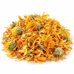 May include: A pile of dried calendula flowers featuring vibrant orange and yellow petals mixed with green, textured calyxes. The loose botanical material consists of individual petals and whole flower heads scattered in a mound.