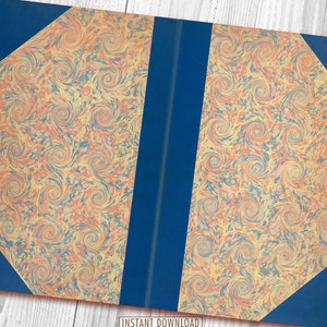 May include: A book with a blue cover and marbled paper pages. The marbling is in shades of orange, yellow, and blue.
