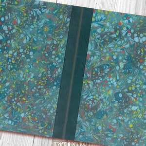 May include: A closed book with a marbled cover in shades of blue, green, red, and yellow. The book has a dark green spine.