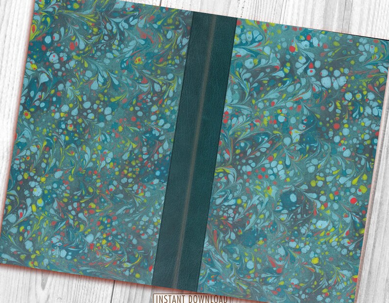 May include: A closed book with a marbled cover in shades of blue, green, red, and yellow. The book has a dark green spine.