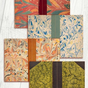 May include: Five different book covers with marbled paper designs. The covers are all different colors and patterns, including red, blue, green, yellow, and orange. The covers are all closed and have a spine.