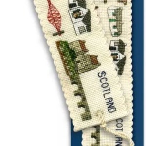 May include: Cross-stitch bookmark kit featuring Scottish landmarks. The cream-coloured bookmarks have a scalloped edge and depict various landmarks in green, brown, and red. The kit includes a blue backing card with the title "Landmarks of Scotland Bookmark Kit."