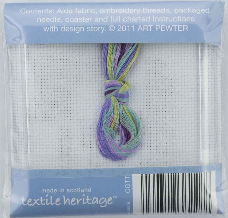 May include: A cross-stitch kit with a white Aida fabric, a bundle of colorful embroidery threads in shades of purple, green, and yellow, and a needle. The package includes instructions and is from Textile Heritage.