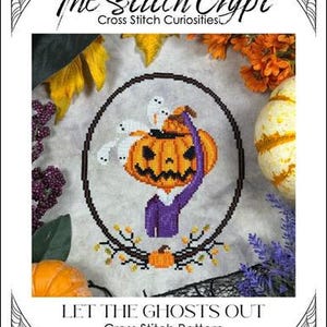 May include: A cross-stitch pattern featuring a Halloween design. The image shows a jack-o'-lantern with ghosts, surrounded by a circular frame. The text reads "The Stitch Crypt" and "Let the Ghosts Out". The design is framed by a spiderweb border.