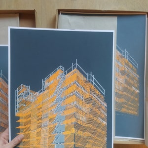 May include: A black and orange print of a building under construction. The building is made of scaffolding and is lit by a bright orange light.