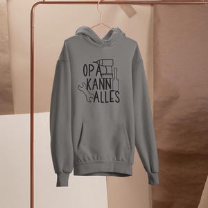 May include: Grey hooded sweatshirt with the text "OPA KANN ALLES" and a drill, wrench, and screwdriver graphic.