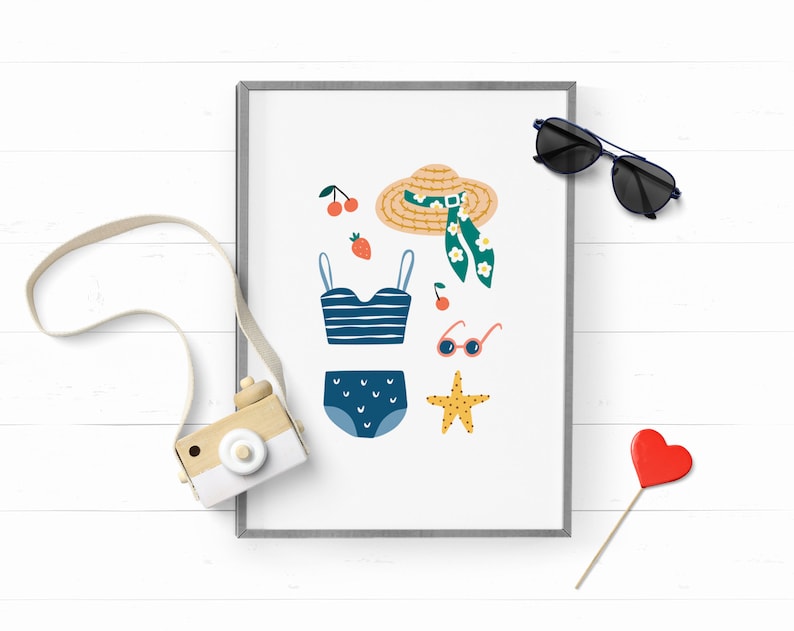 May include: A framed print with a white background and illustrations of summer vacation items. The items include a straw hat with a green floral scarf, a blue and white striped swimsuit top, a blue swimsuit bottom with white polka dots, a pair of sunglasses, a red strawberry, a red cherry, a starfish, and a pair of pink sunglasses.