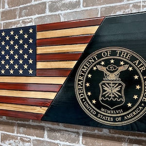 May include: A wooden American flag with a red, white, and blue design. The flag is split diagonally with a black background on the right side. The black background features a gold seal with the words "Department of the Air Force, United States of America" and the year "MCMXLVII".