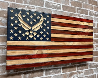 May include: A wooden American flag with a carved Air Force emblem in the blue field. The flag is made of natural wood with a red, white, and blue color scheme.