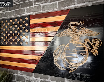 May include: A wooden American flag with a red, white and blue colour scheme is displayed on a brick wall. The flag is split diagonally, with the Marine Corps emblem on the right side. The emblem is a gold eagle with a globe and anchor, and the words "Semper Fidelis" are inscribed above the eagle. The flag has a glossy finish.