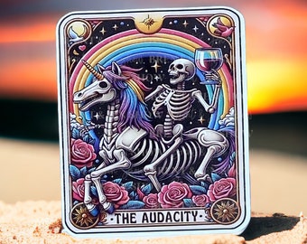 May include: A tarot card illustration featuring a skeleton riding a skeletal unicorn against a dark background with a rainbow, stars, and roses. The card reads "The Audacity".