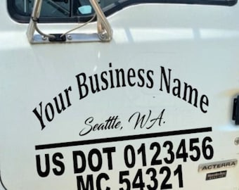 May include: White truck door with a black decal that says "Your Business Name" with the text "Seattle, WA." below. The decal also includes the text "US DOT 0123456 MC 54321".