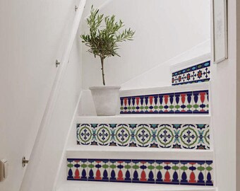 May include: White stairs with a decorative border of blue, green, red, and white patterned tiles. A small potted plant sits on the top step.