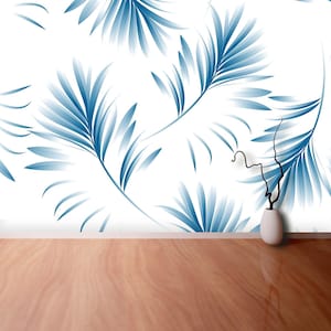 May include: A white background with a blue and white tropical leaf pattern. A small, white vase with a dried branch sits on a wooden floor.