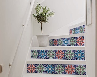 May include: White stairs with a decorative pattern of blue, green, red, and white tiles on the risers. A small potted plant is on the top step.