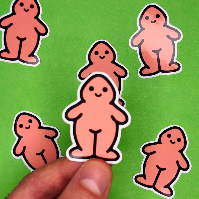 May include: A collection of peach-colored stickers with a cartoonish figure design. Each sticker features a smiling face and a simple body outline with black detailing. The stickers are on a green background.
