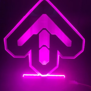 May include: A pink LED light shaped like an upward arrow, with a black outline and a clear acrylic base.