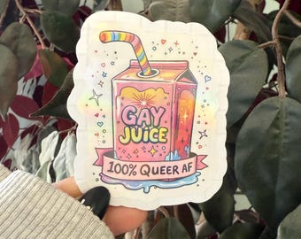 May include: A white sticker with a pink and orange cartoon juice box with a rainbow straw. The juice box says "Gay Juice" and "100% Queer AF" in a rainbow font.