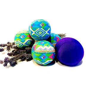 May include: Five decorative Easter eggs, four are blue, green, white, and pink with geometric patterns, and one is solid purple.