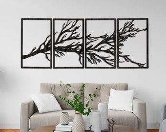 May include: A four-piece wall art set featuring a black silhouette of a tree branch with delicate branches extending out. The art is displayed on a white wall above a beige sofa with a coffee table in front of it.