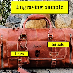 May include: A brown leather duffel bag with a black logo, the name "Jack" and a black panther graphic engraved on the front. The bag also has a tag with the word "Logo" and a strap with the word "Initials" on it.