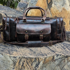 Handmade vintage leather duffle bag with shoulder strap, perfect for travel, gym, or weekend use. Rustic brown full-grain leather bag for men.
