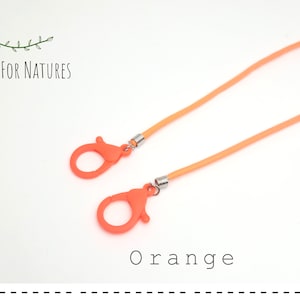 May include: Orange lanyard with two plastic orange clips and silver metal clasps. "Shop for Natures" and "Orange" are printed on the white background.