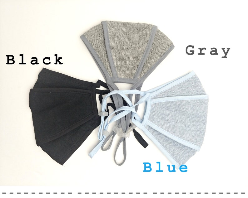 May include: Three face masks in black, gray, and blue. The masks are made of a soft, breathable fabric and have adjustable ear loops.