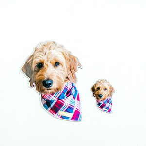 May include: Two dog stickers, one large and one small, both featuring a brown and white dog wearing a red and blue plaid bandana.