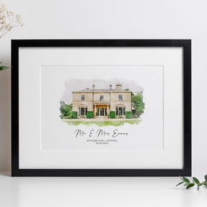May include: A framed watercolor print of a stately beige building with a black frame. The building has multiple windows and a central entrance. The text "Mr & Mrs Evans" and "Wynard Hall Suffolk 26.03.2023" are written below the building.