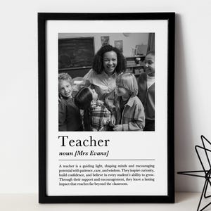 May include: Black and white framed print featuring a group of children and a teacher. The word "Teacher" is displayed in large font, with a definition below. The print is a thoughtful gift for educators.