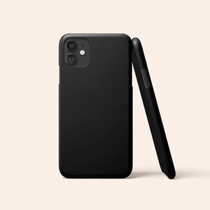 May include: A black phone case with a camera lens on the back.