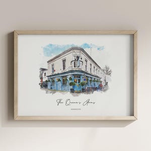 May include: A framed watercolor print of a corner building with blue painted walls and large windows. The text below the illustration reads The Queen's Arms and KENSINGTON. The artwork is displayed in a light-colored wooden frame.