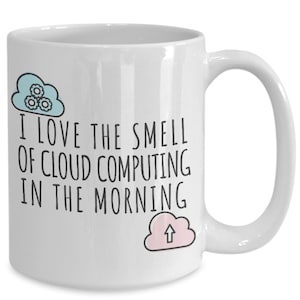 May include: White ceramic coffee mug with a black and white graphic that says "I love the smell of cloud computing in the morning". The graphic includes two blue and pink clouds with gears and an arrow.