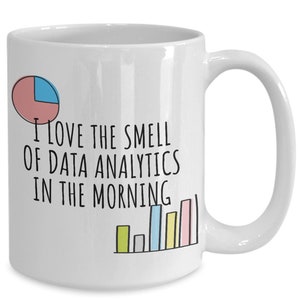 May include: White ceramic coffee mug with a black graphic that says "I love the smell of data analytics in the morning". The graphic includes a pie chart and a bar graph.