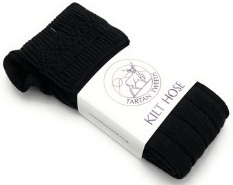 May include: Black kilt hose with a ribbed texture. The hose is packaged and labeled with the text "Tartan Tweeds Kilt Hose" and a website address.